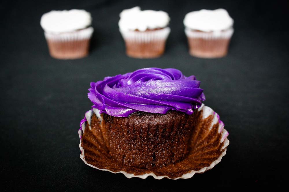 Regal Purple coloured icing over a chocolate muffin